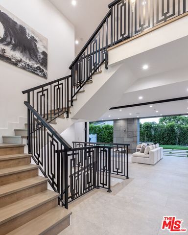 a view of staircase with lots of white furniture