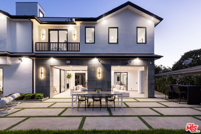 a view of a house with patio and a garden