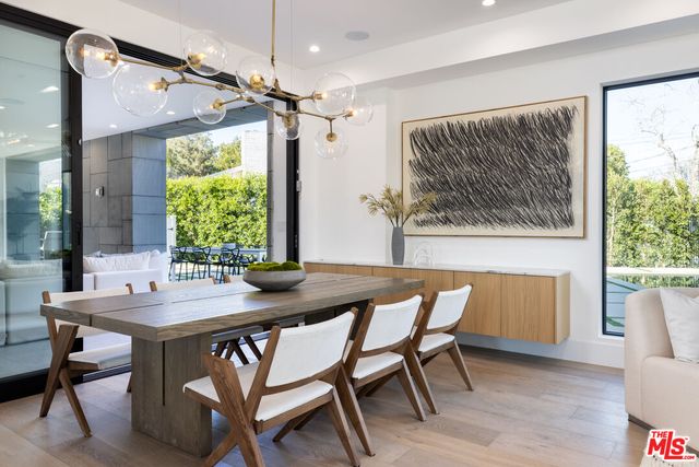a dining room with a wooden table and chairs