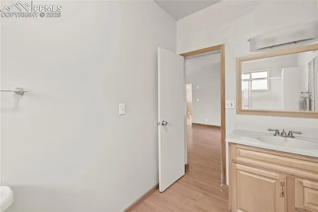 a view of hallway with wooden floor