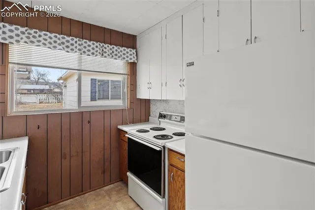 a kitchen with stainless steel appliances granite countertop cabinets and a stove top oven
