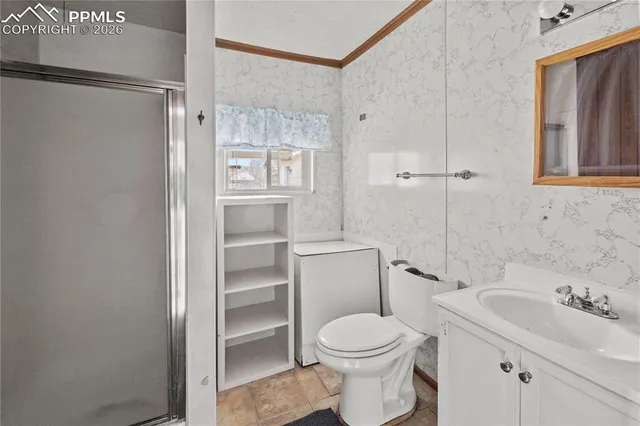 a bathroom with a toilet a sink and shower