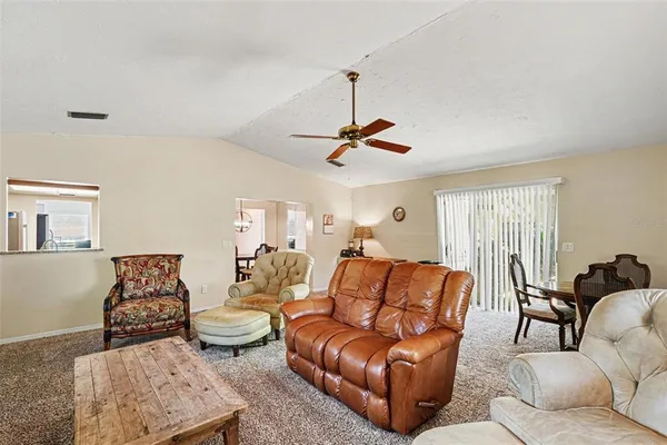 a living room with furniture wooden floor and window