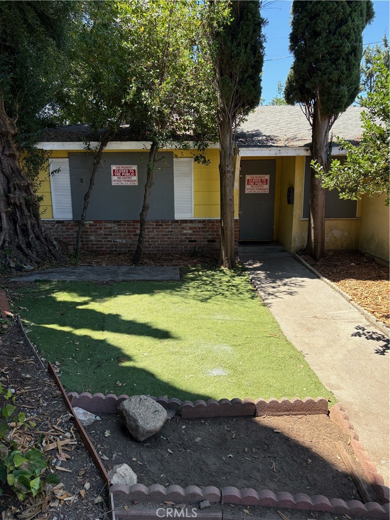 a front view of a house with garden