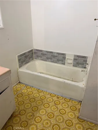 a bathroom with a bathtub and shower