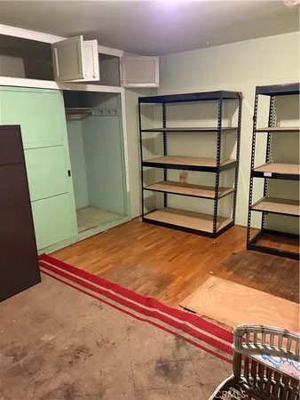 a bedroom with a bed and cabinets