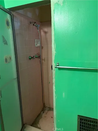 a bathroom with a shower and a mirror