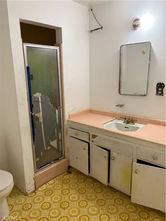 a bathroom with a sink a toilet and mirror