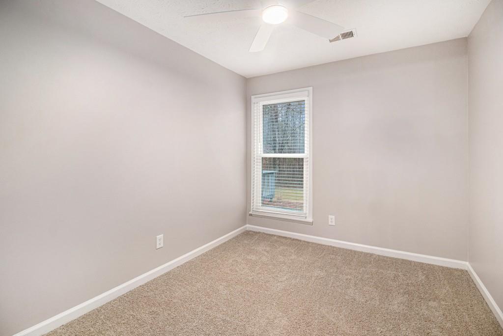 5524 Dorsett Shoals Road Douglasville, GA 30135 - Photo 15 of 33 an empty room with windows
