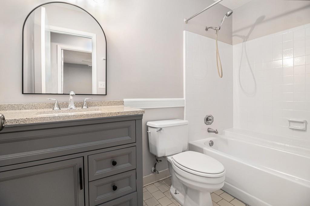 5524 Dorsett Shoals Road Douglasville, GA 30135 - Photo 17 of 33 a bathroom with a sink a toilet and a mirror