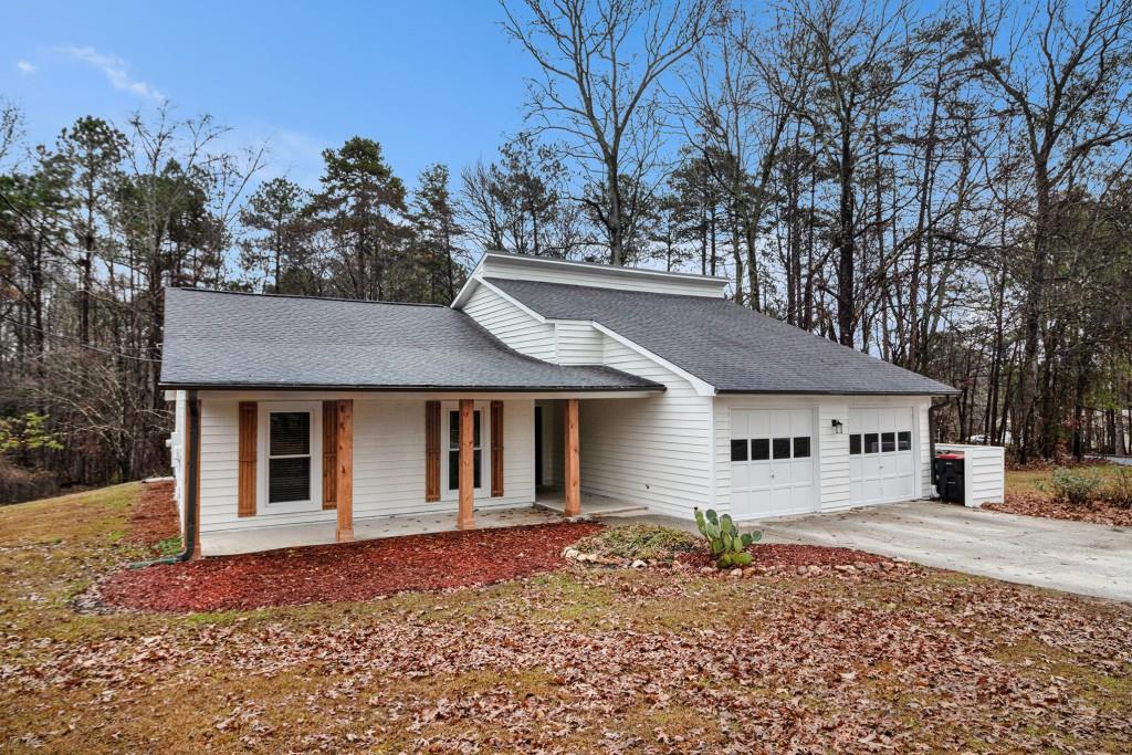 5524 Dorsett Shoals Road Douglasville, GA 30135 - Photo 20 of 33 a backyard of a house with large trees