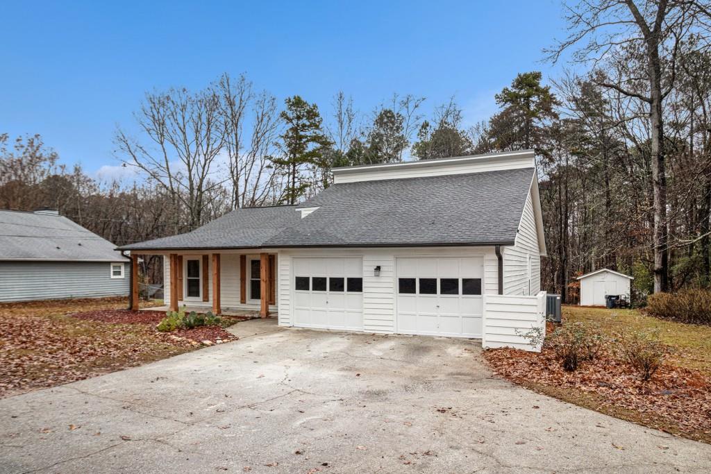 5524 Dorsett Shoals Road Douglasville, GA 30135 - Photo 21 of 33 a front view of a house with a yard and garage