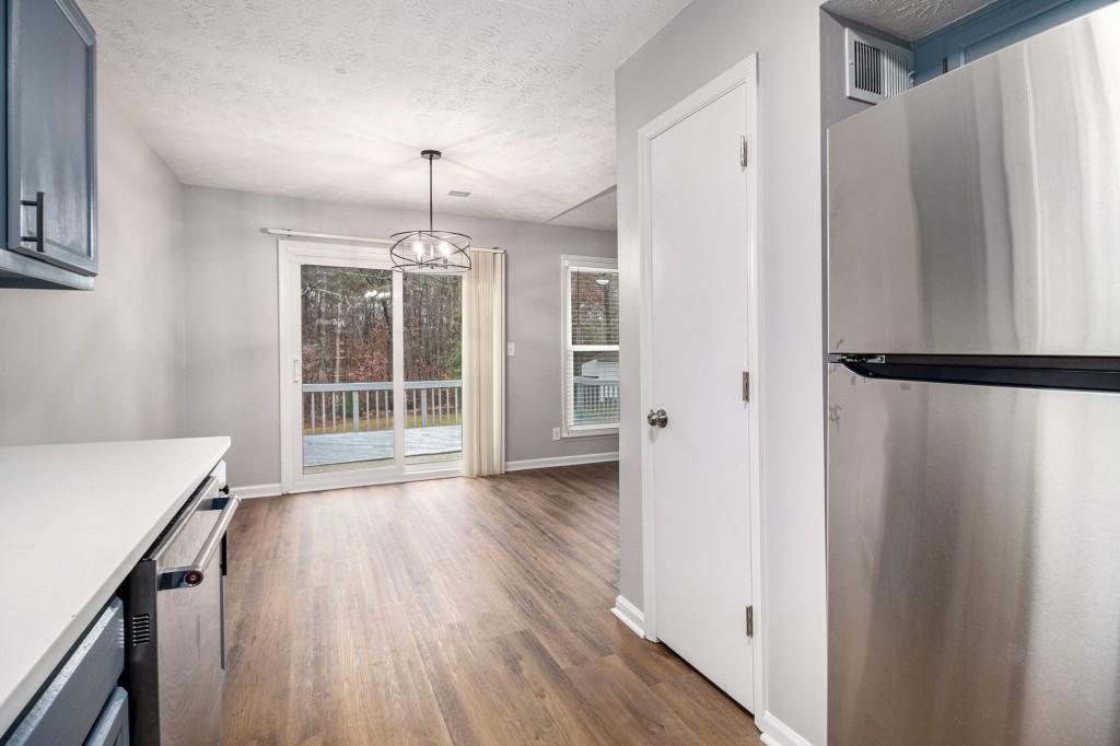 5524 Dorsett Shoals Road Douglasville, GA 30135 - Photo 8 of 33 a big room with wooden floor and windows