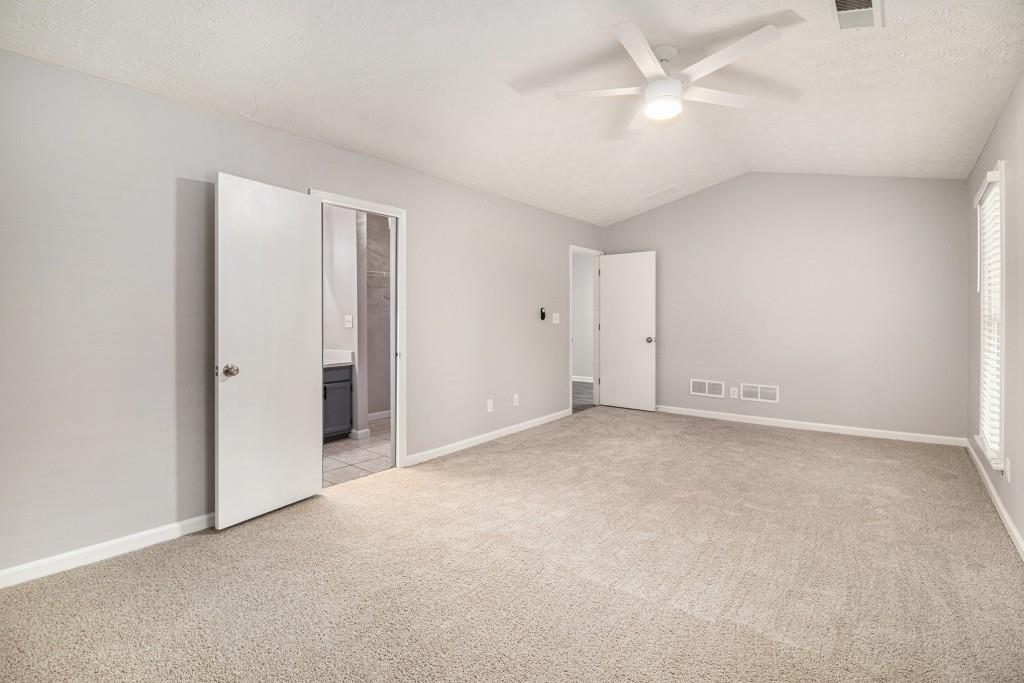 5524 Dorsett Shoals Road Douglasville, GA 30135 - Photo 10 of 33 an empty room with a ceiling fan and a window