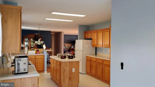 a kitchen with sink a refrigerator and cabinets