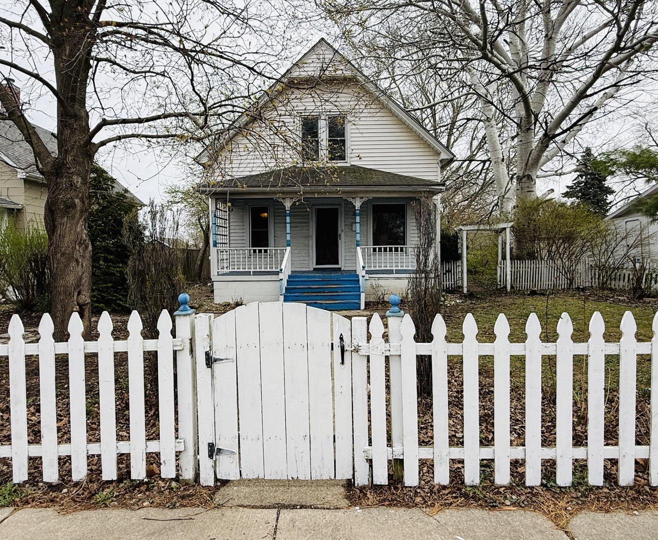 a front view of white house with a small yard