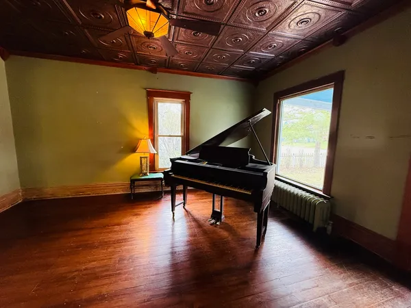 a room with wooden floors and pool table