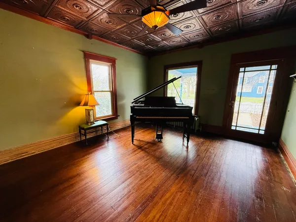 a living room with furniture and a wooden floor