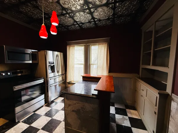 a kitchen with stainless steel appliances a stove a sink and a microwave