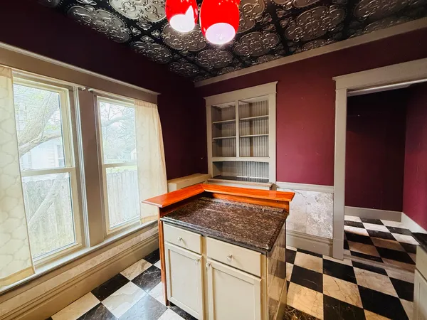 a room with pool table and a window