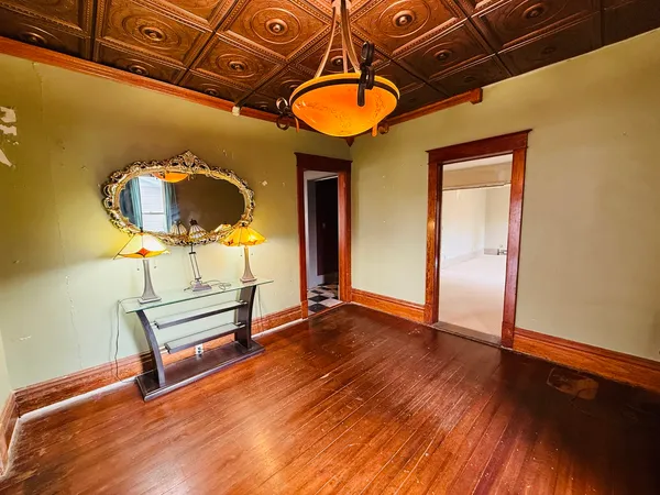 a view of a room with wooden floor and pool table