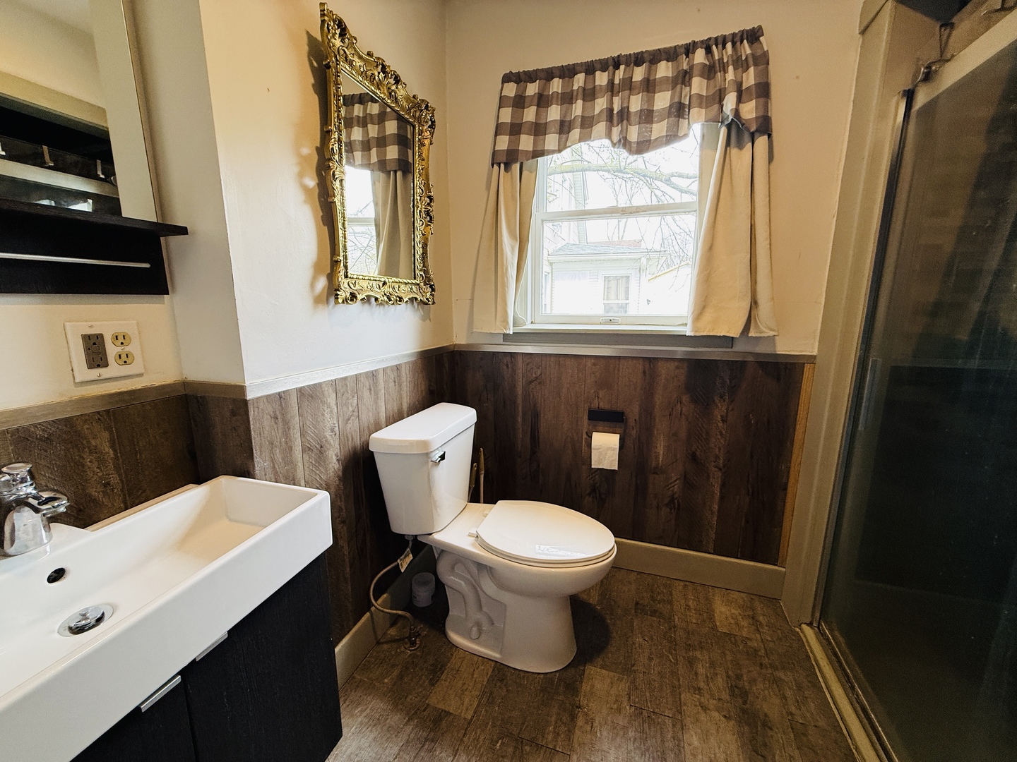 312 North Chicago Street Dwight, IL 60420 - Photo 9 of 16 a bathroom with a sink a toilet a window and mirror