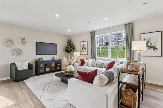 a living room with furniture large window and flat screen tv