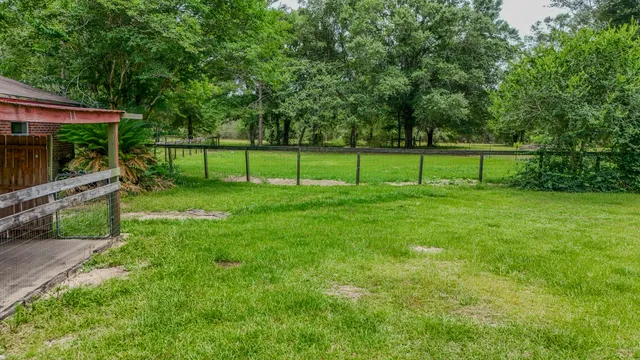 a backyard of a house with table and chairs