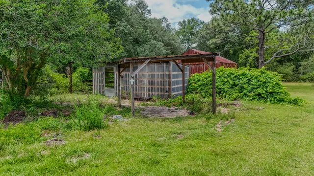 a view of a backyard with wooden fence and a cabin