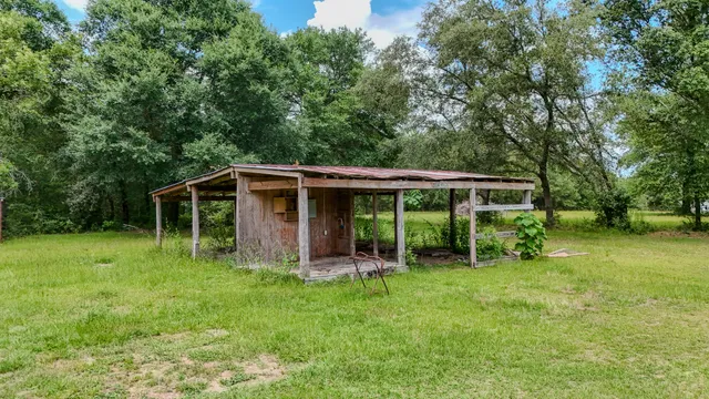 a front view of a house with yard and green space