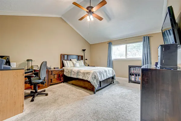 a spacious bedroom with a bed and a chandelier
