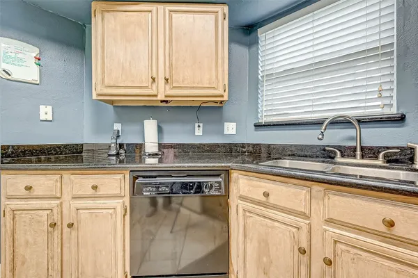a kitchen with stainless steel appliances granite countertop a sink a stove and cabinets