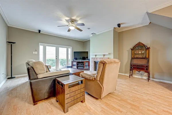 a living room with furniture and a flat screen tv with wooden floor
