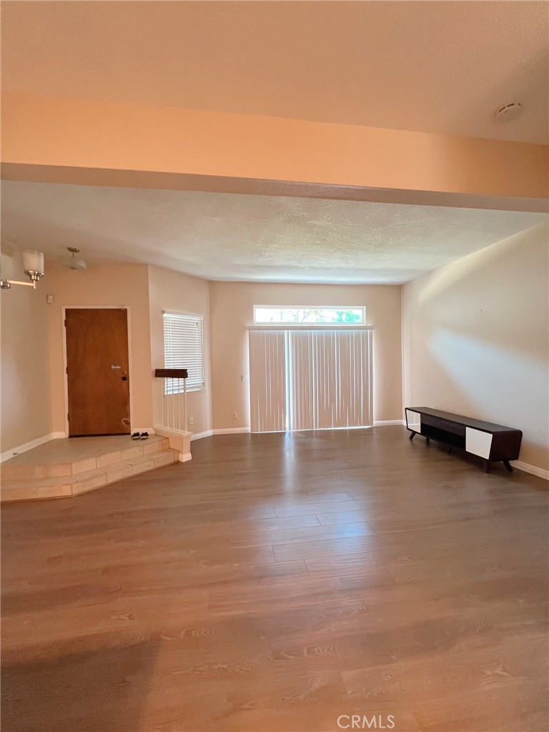 47 Brownfield Lane Phillips Ranch, CA 91766 - Photo 3 of 10 a view of empty room with wooden floor and window