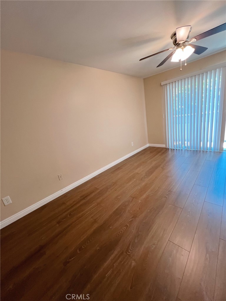47 Brownfield Lane Phillips Ranch, CA 91766 - Photo 7 of 10 a view of an empty room with wooden floor and a window