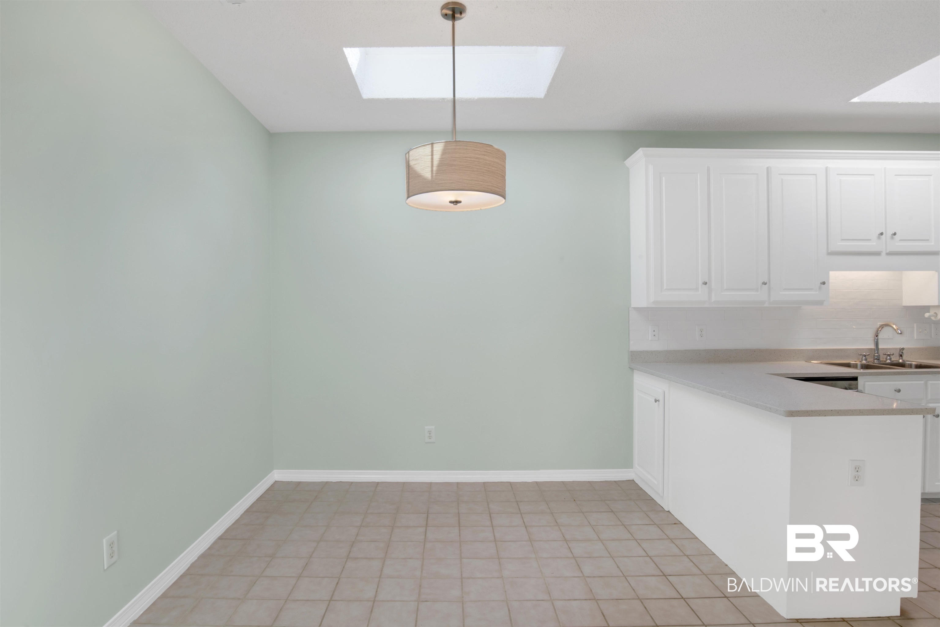 125 Woodruff Court Mobile, AL 36608 - Photo 10 of 27 Unfurnished breakfast area featuring light tile patterned flooring and a skylight