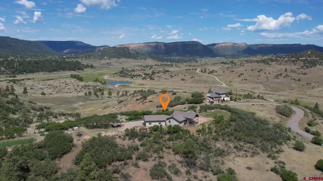 a view of a dining room with furniture a chandelier and wooden floor