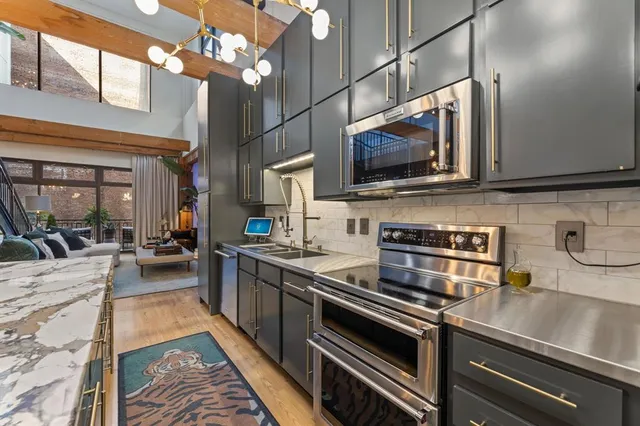 a kitchen with stainless steel appliances granite countertop a stove and a sink