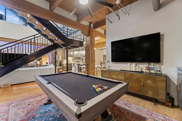 a living room with a flat screen tv and a floor to ceiling window