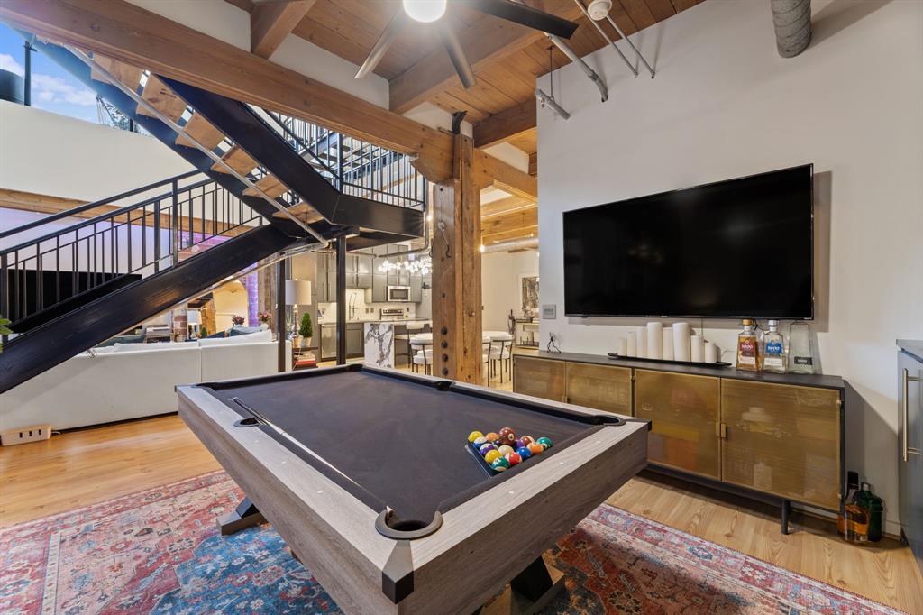 509 Elm Street, Unit 601 Dallas, TX 75202 - Photo 18 of 37 a living room with a flat screen tv and a floor to ceiling window