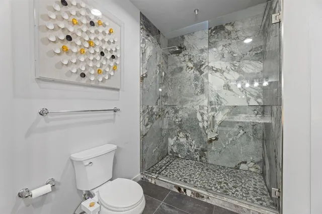 a bathroom with a toilet and shower