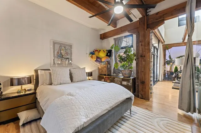 a bedroom with a large bed and a chandelier