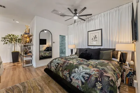 a bedroom with a large bed and a chandelier