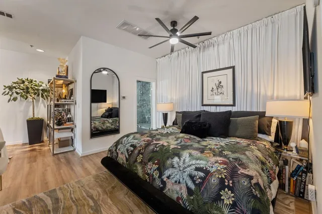 a bedroom with a large bed and a chandelier