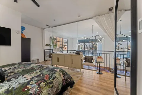 a bedroom with a bed and a flat screen tv