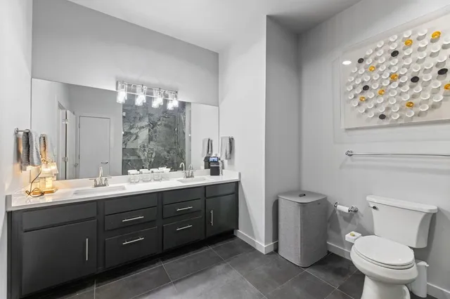 a bathroom with a toilet sink and mirror