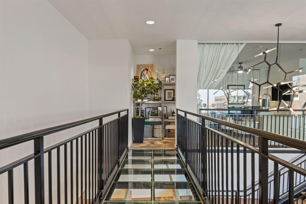 509 Elm Street, Unit 601 Dallas, TX 75202 - Photo 33 of 37 a view of a hallway with wooden floor and stairs