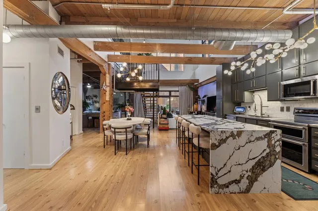 a living room with lots of furniture and kitchen