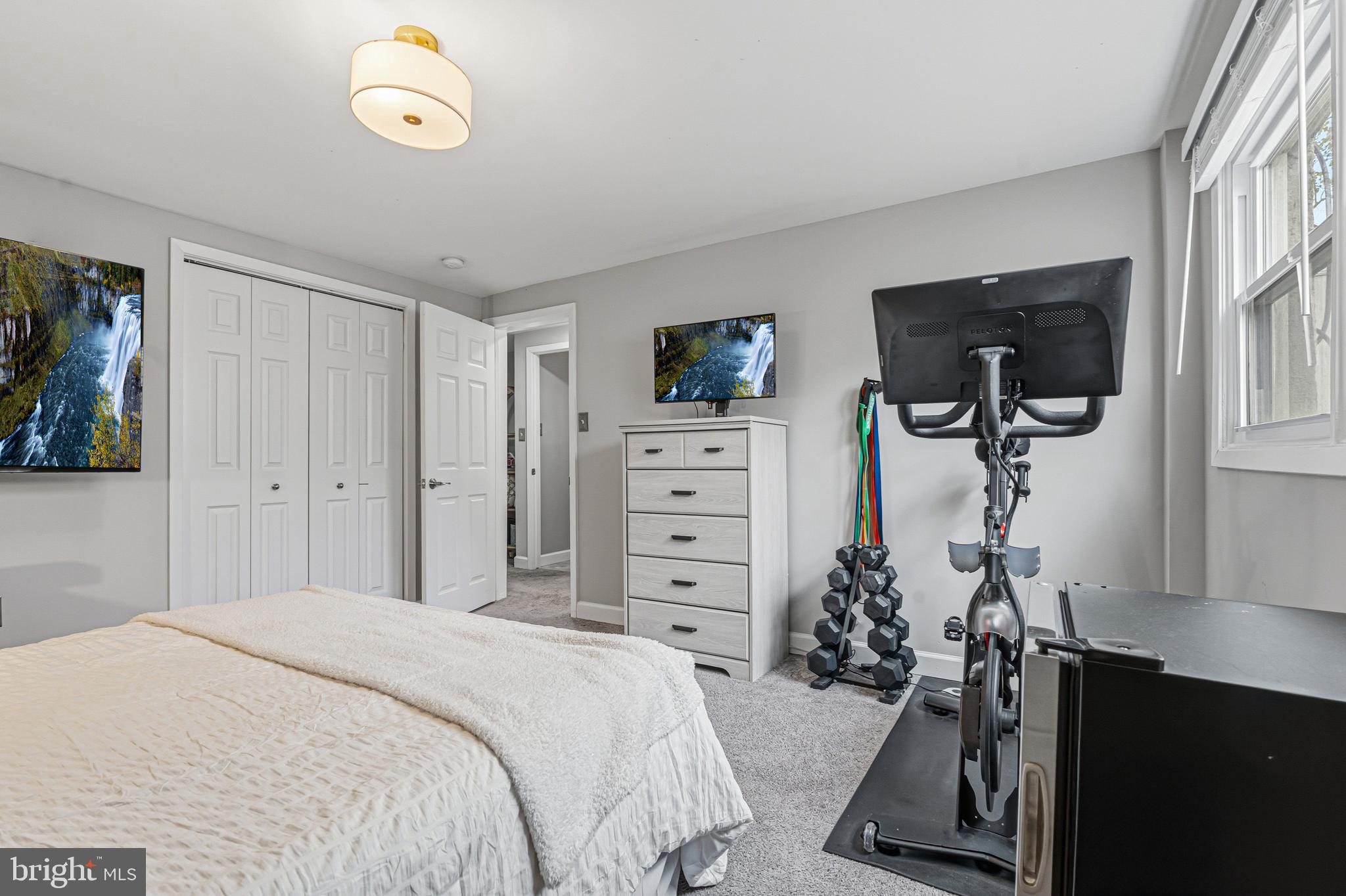 231 East Timonium Road Lutherville-Timonium, MD 21093 - Photo 51 of 66 a bedroom with a bed and a flat tv screen on the dresser