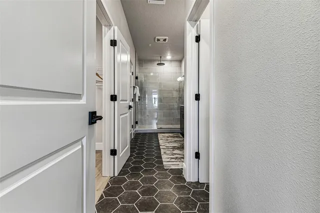 a bathroom with a mirror and a shower